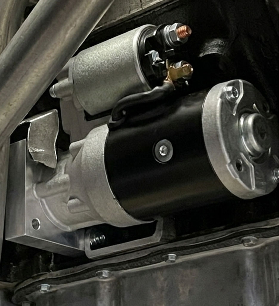 Side-by-side comparison of a full-size stock starter and a compact high-torque mini starter on a workbench