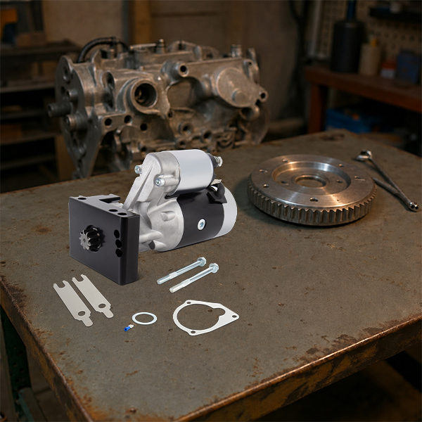 High-torque mini starter on a shop workbench with a flywheel and installation hardware for gear reduction starter setup.